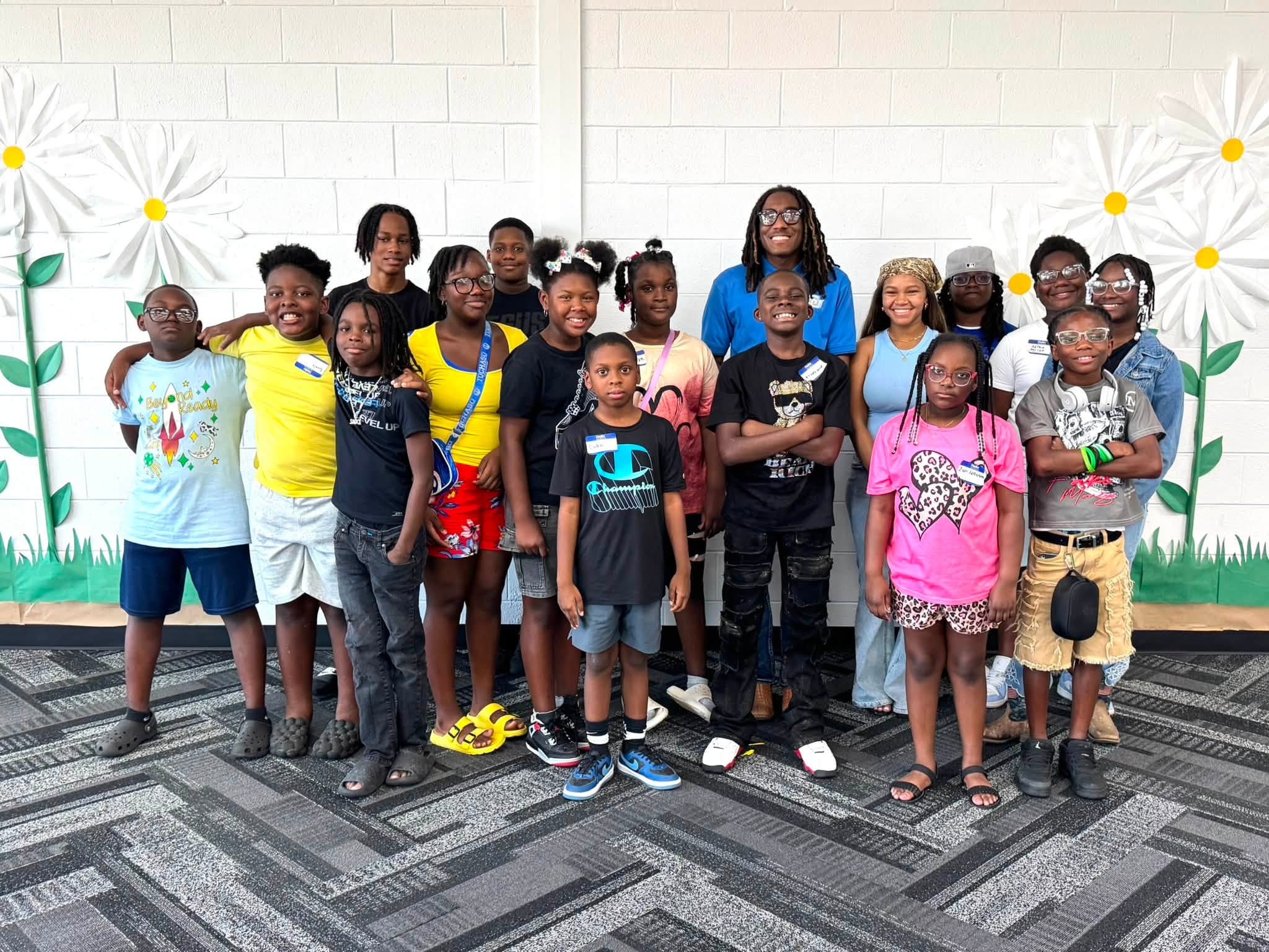A man with a group of kids posing for a picture.